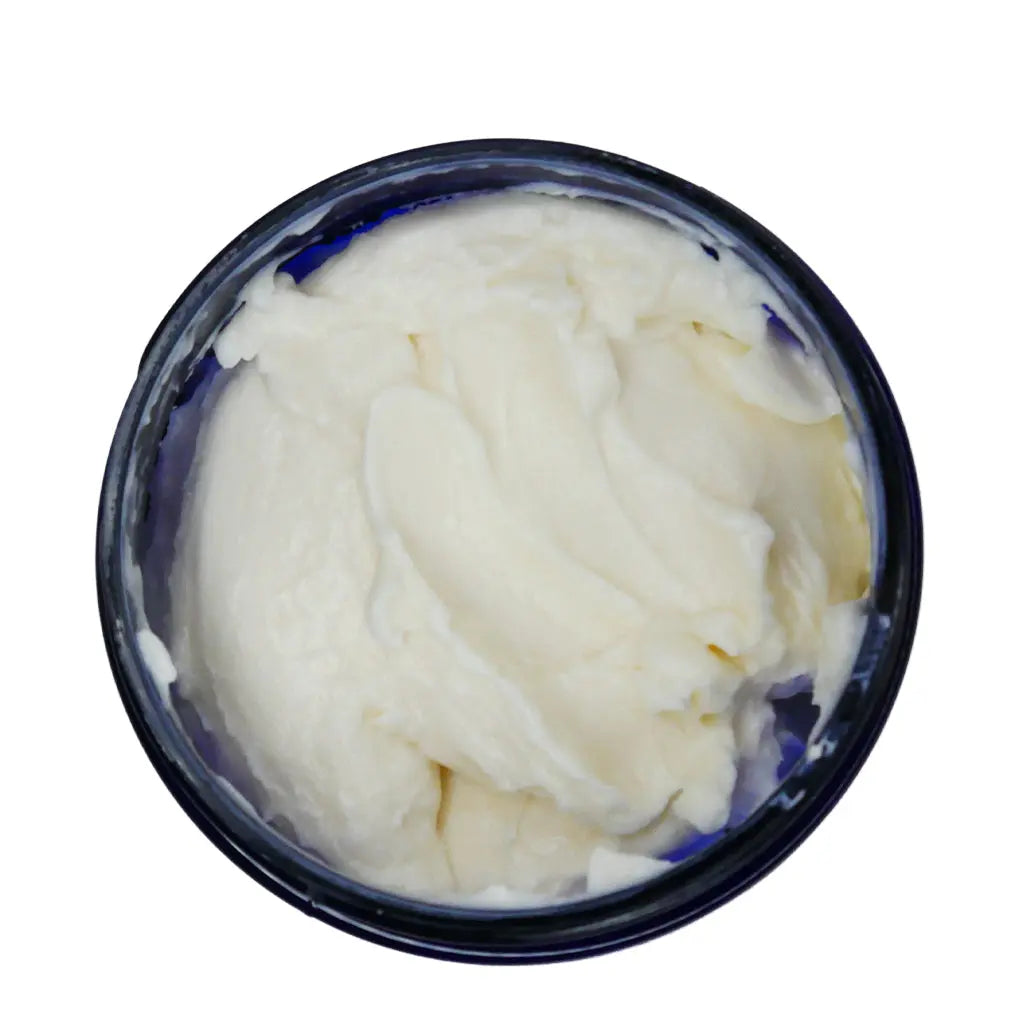 Container of white cream or frosting on a white background